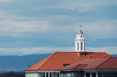 Wilson Hall at James Madison University with the Shenandoah Valley mountains behind it